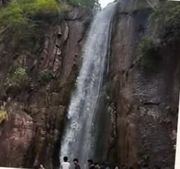 Dhani Waterfall falling down a dark rock face