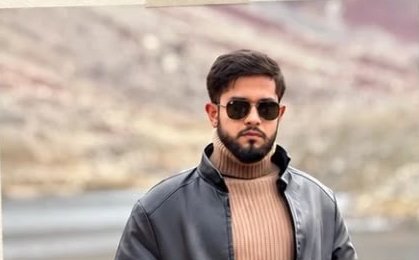 Umer Javaid, in a leather jacket in the mountains