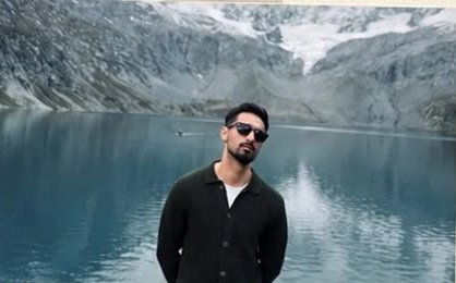 Ashhad Siddiqui, standing by a glacial lake